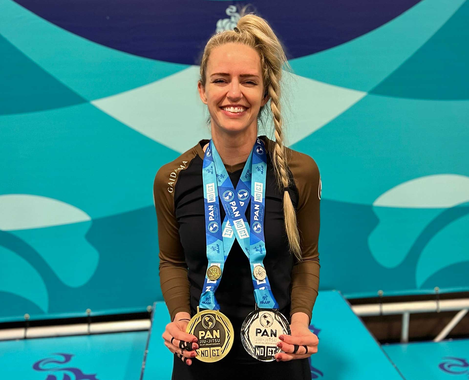 Photo of an athlete wearing two gold medals for PAN Ju-Jitsu