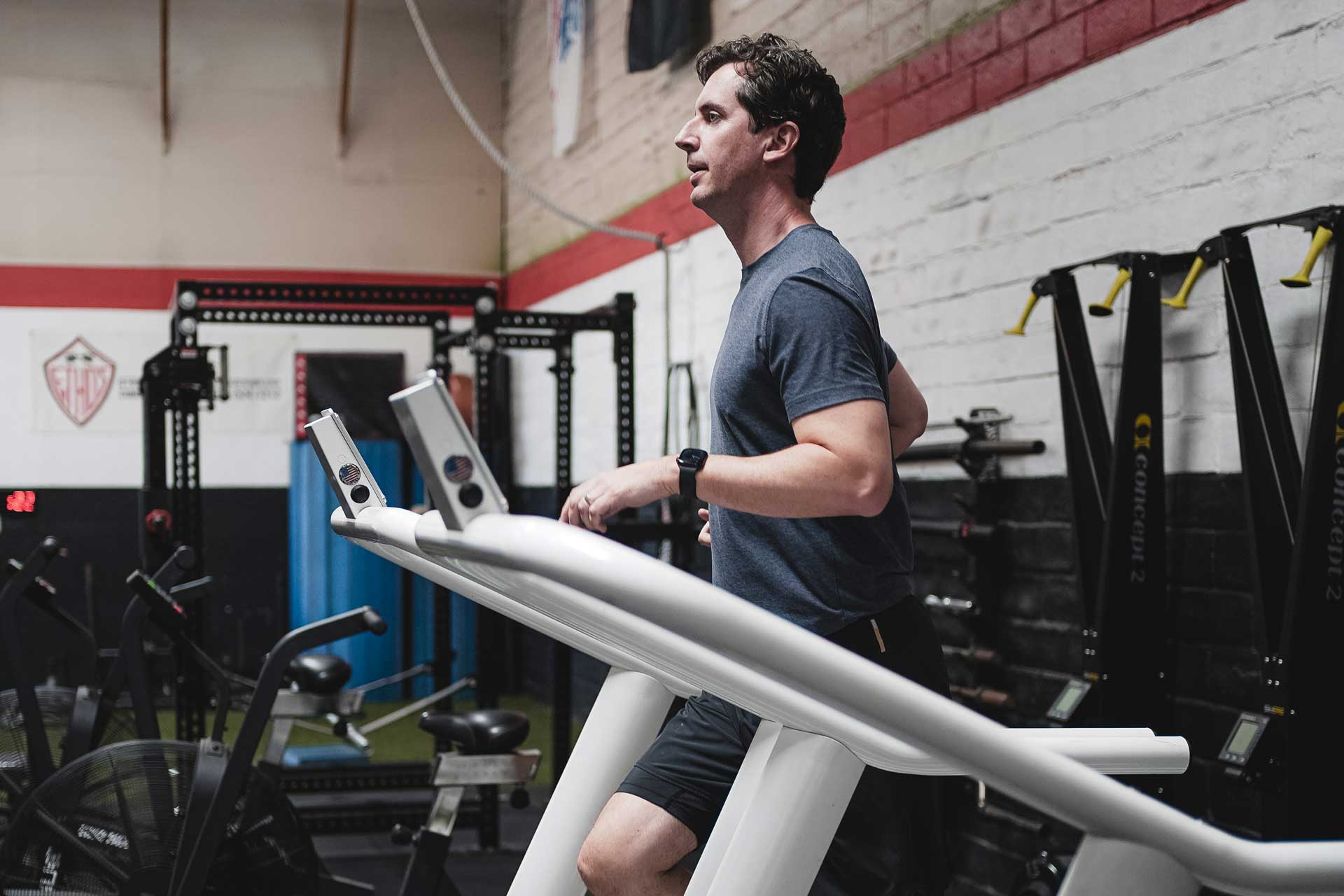 A person excercising by running on a treadmill at the gym