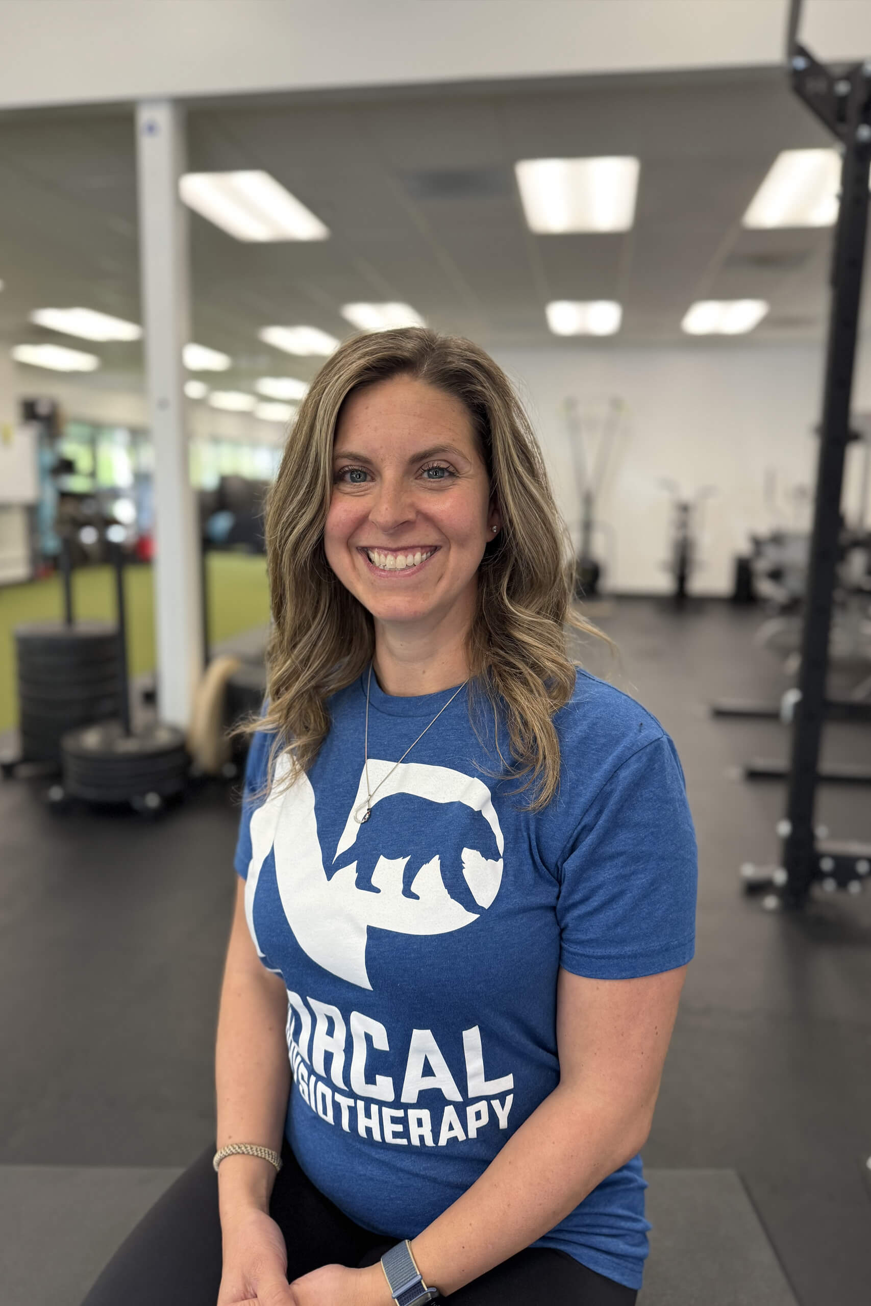 Becky Bujwit seated in a gym